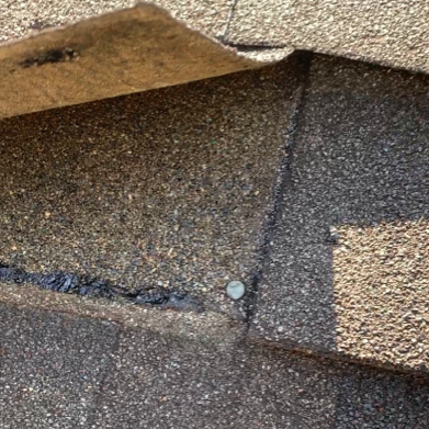 Example of a nail in a shingle butt joint showing improper shingle nailing pattern.